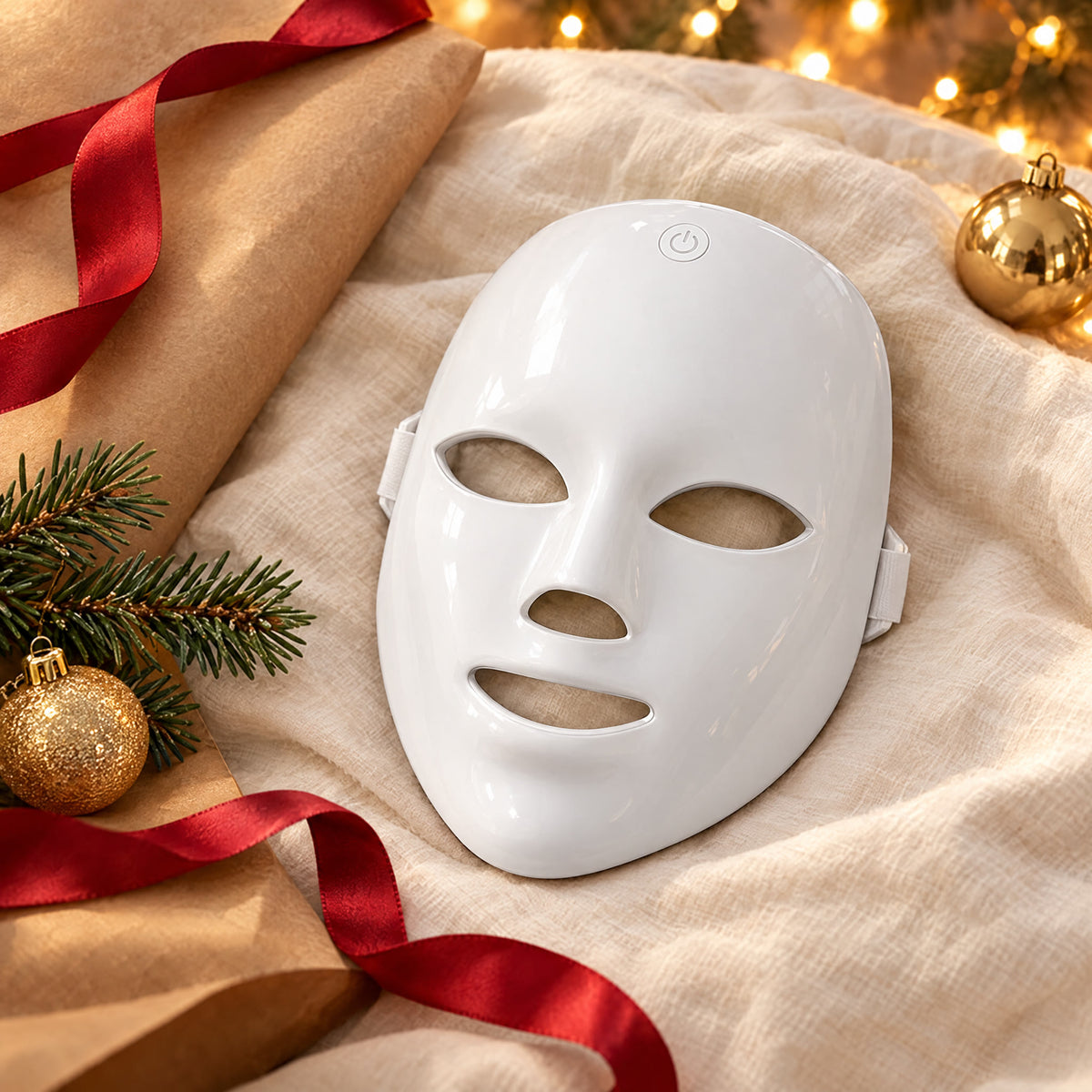 LED face mask with Christmas wrapping paper and a red ribbon